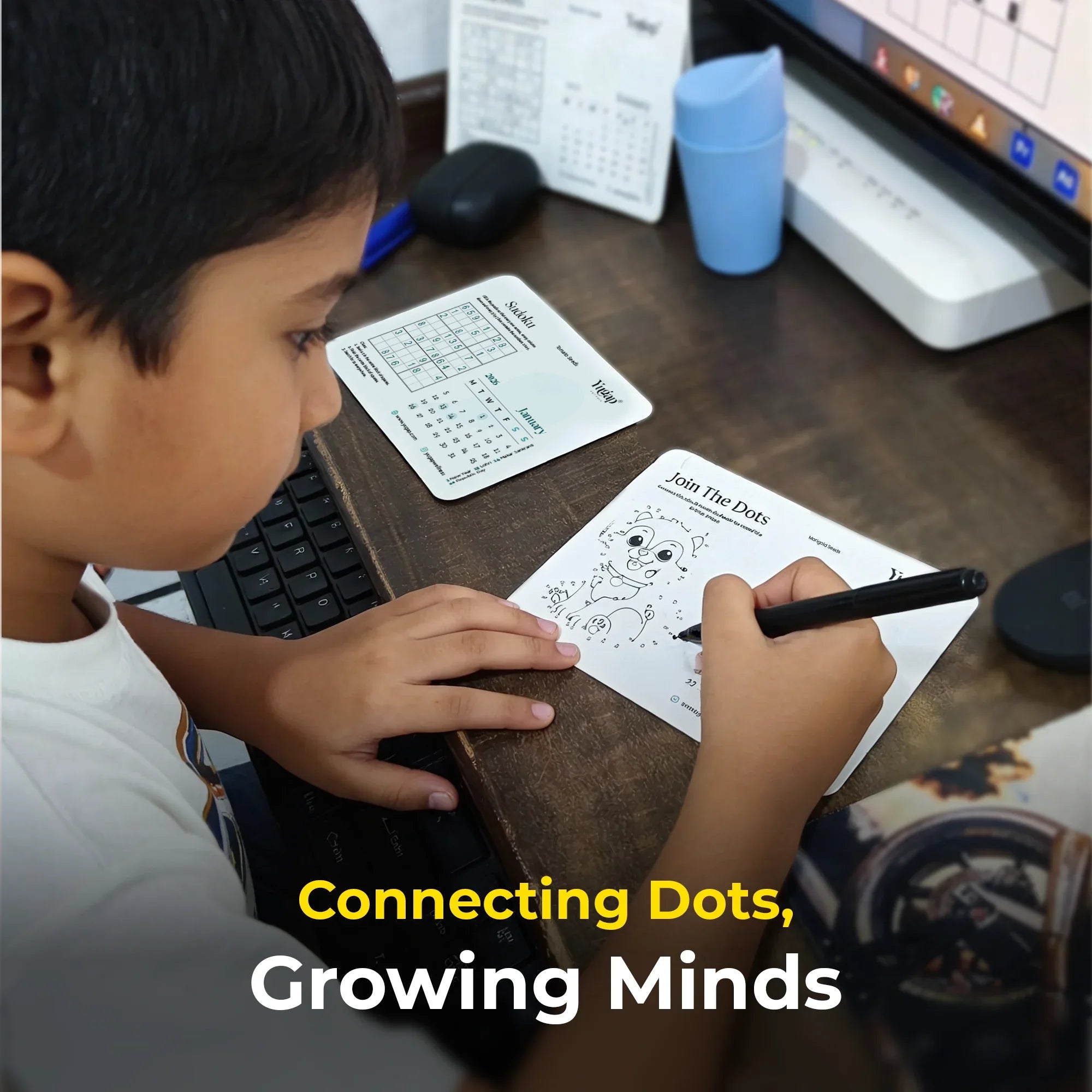 Child connecting dots on a worksheet with text 'Connecting Dots, Growing Minds' on a desk.