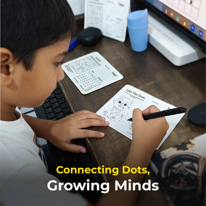 Child connecting dots on a worksheet with text 'Connecting Dots, Growing Minds' on a desk.