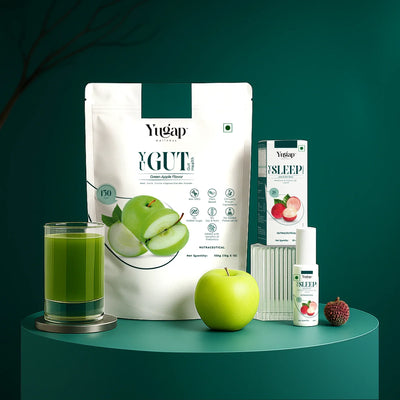 Yugap YGute apple probiotic pouch, Yugap Sleep spray box and bottle, fresh green apple, and green juice displayed on dark green pedestal, highlighting digestive wellness and restful sleep combo